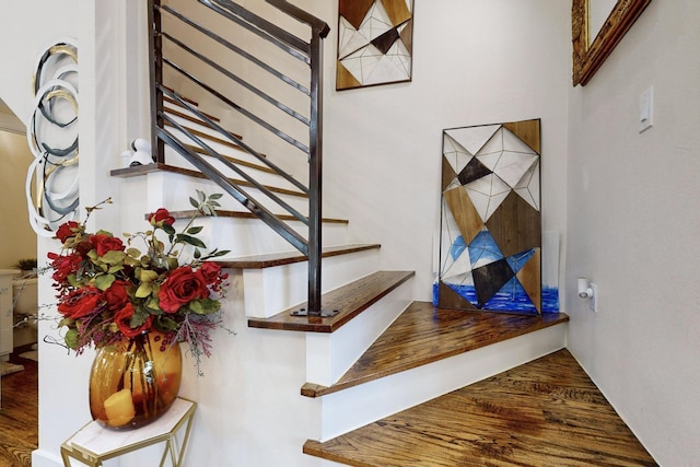 stairway with hardwood / wood-style floors