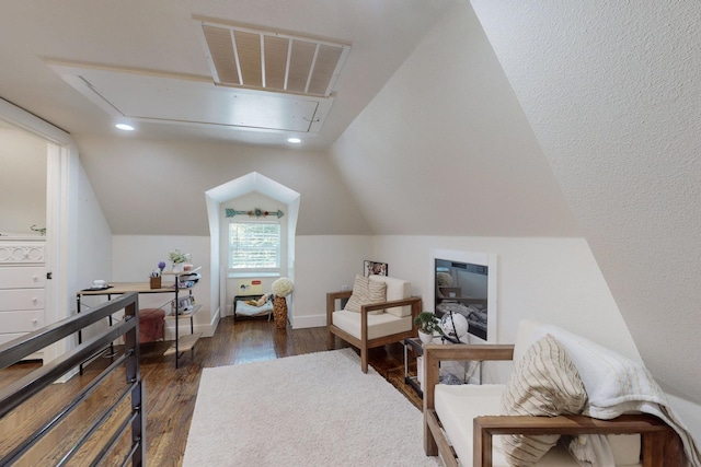 living area with dark hardwood / wood-style floors and vaulted ceiling