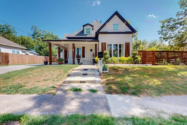 view of front facade with covered porch and a front lawn