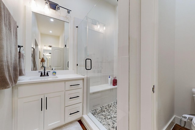 bathroom with vanity and a shower with shower door