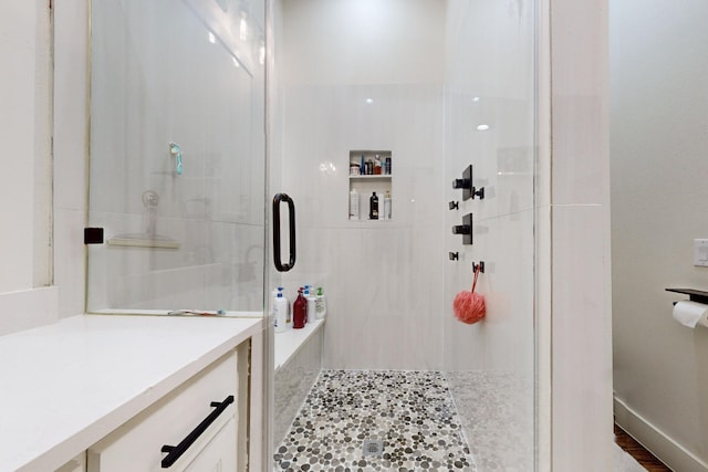 bathroom with vanity and a shower with door