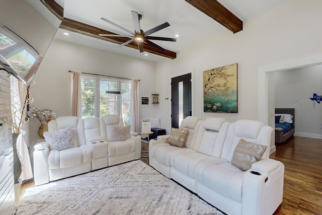 living room with ceiling fan, beamed ceiling, and dark hardwood / wood-style floors