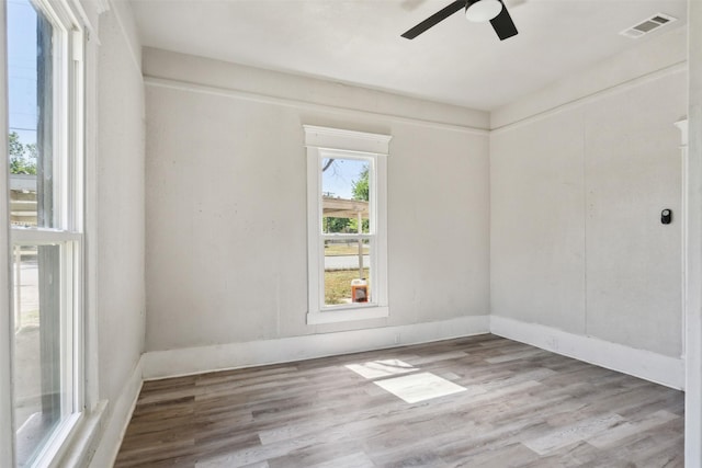 unfurnished room with ceiling fan and light wood-type flooring