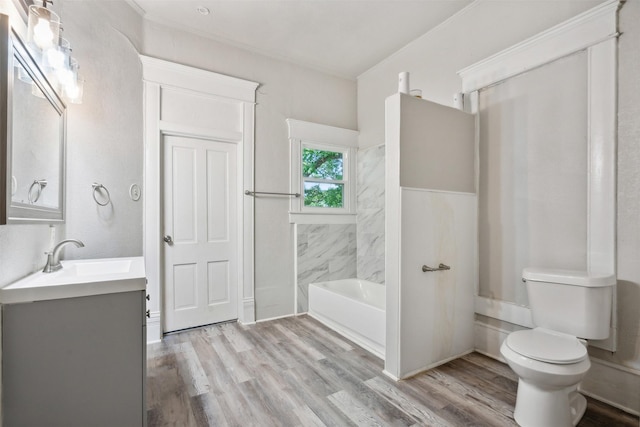 full bathroom with vanity, hardwood / wood-style floors,  shower combination, and toilet