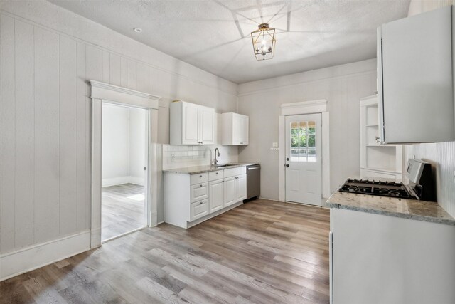 kitchen featuring range, white cabinets, sink, light hardwood / wood-style floors, and dishwasher