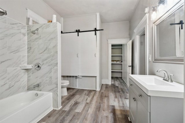 full bathroom featuring hardwood / wood-style flooring, vanity, toilet, and tiled shower / bath combo