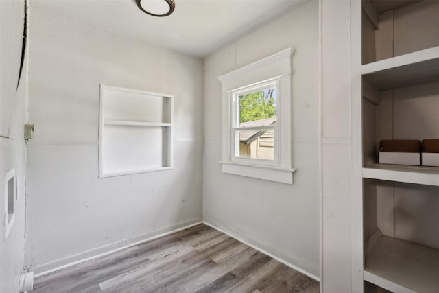 spare room featuring wood-type flooring