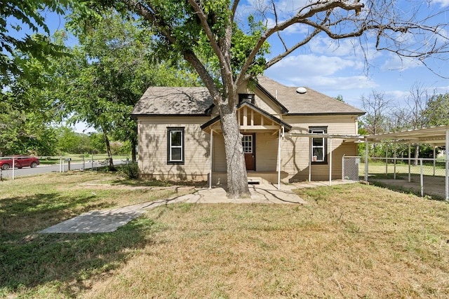 back of property featuring a lawn