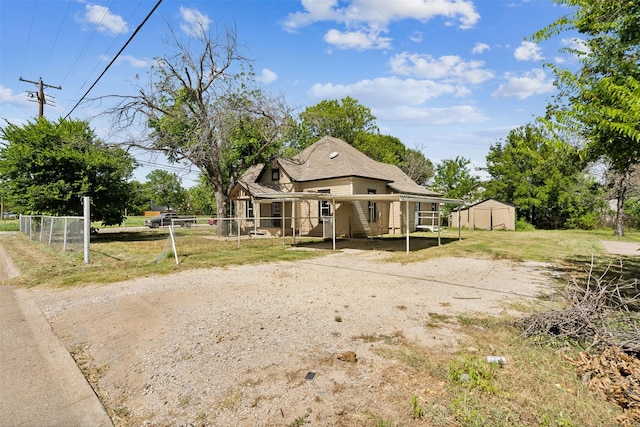 view of front facade with a storage shed