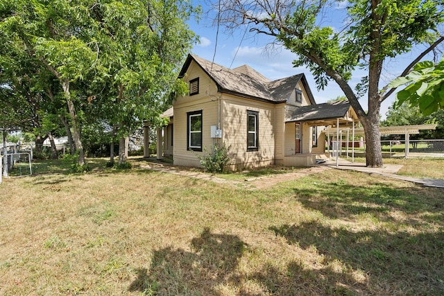 back of property featuring a lawn