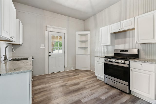 kitchen featuring white cabinetry, sink, and stainless steel gas range