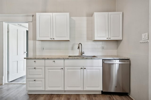 kitchen with dark hardwood / wood-style floors, white cabinetry, dishwasher, sink, and light stone countertops