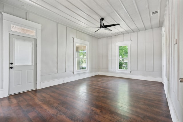 unfurnished room featuring dark hardwood / wood-style flooring, a wealth of natural light, and ceiling fan