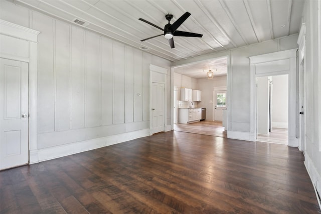 unfurnished living room with ceiling fan, dark hardwood / wood-style flooring, and sink