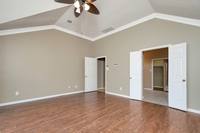 unfurnished bedroom featuring hardwood / wood-style floors, a textured ceiling, ceiling fan, and ornamental molding