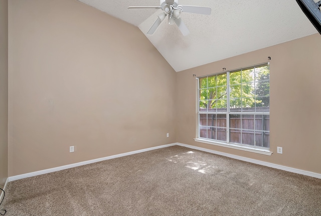 carpeted spare room with a textured ceiling, ceiling fan, and lofted ceiling