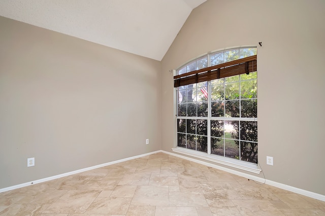 empty room featuring vaulted ceiling