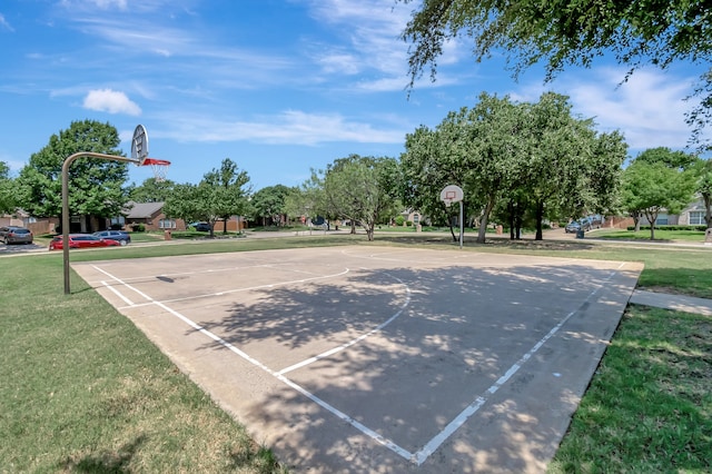 view of sport court with a yard