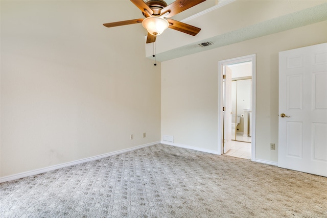 carpeted spare room with ceiling fan