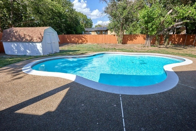 view of swimming pool with a storage unit