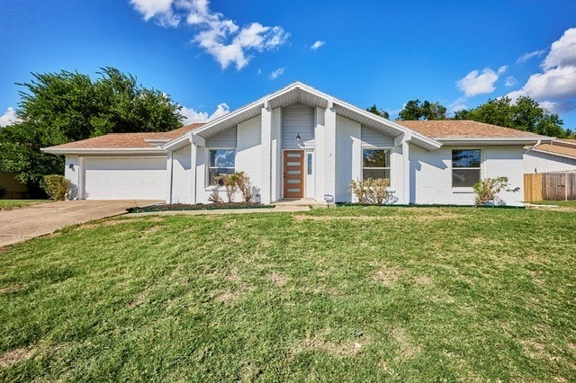 ranch-style home featuring a front yard and a garage