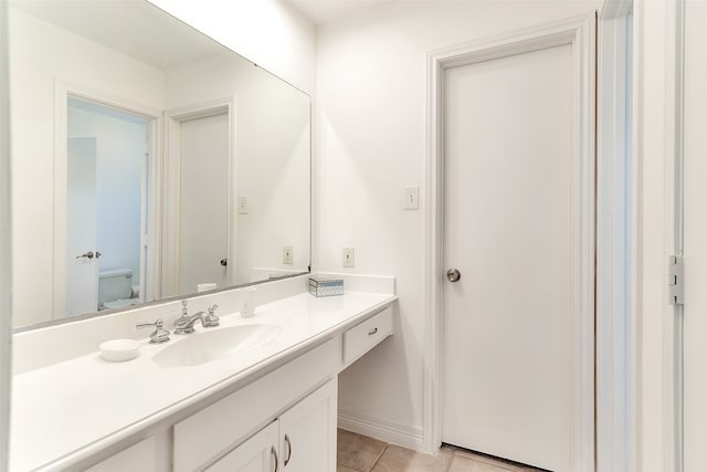 bathroom with vanity, tile patterned flooring, and toilet