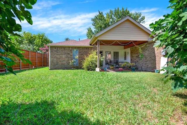 rear view of house with a lawn