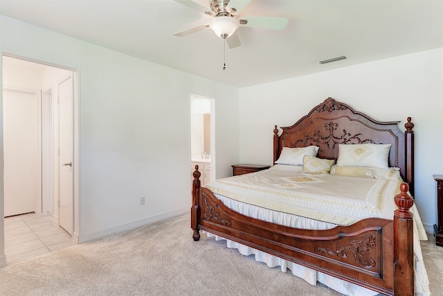 bedroom with ceiling fan, connected bathroom, and light colored carpet