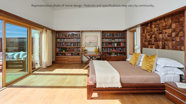 bedroom with high vaulted ceiling and hardwood / wood-style floors