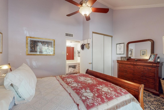 bedroom featuring ensuite bath, a high ceiling, ornamental molding, a closet, and ceiling fan