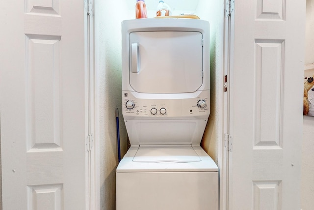 laundry area with stacked washer / dryer