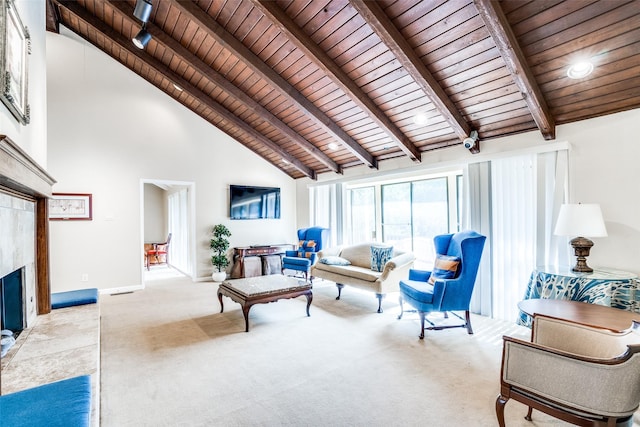 living room featuring a tiled fireplace, beamed ceiling, wood ceiling, and light colored carpet