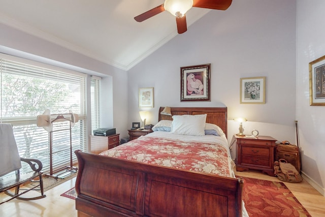 bedroom featuring ceiling fan, light wood-type flooring, vaulted ceiling, and crown molding