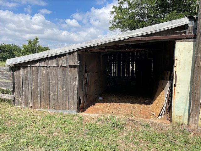 view of horse barn with an outdoor structure