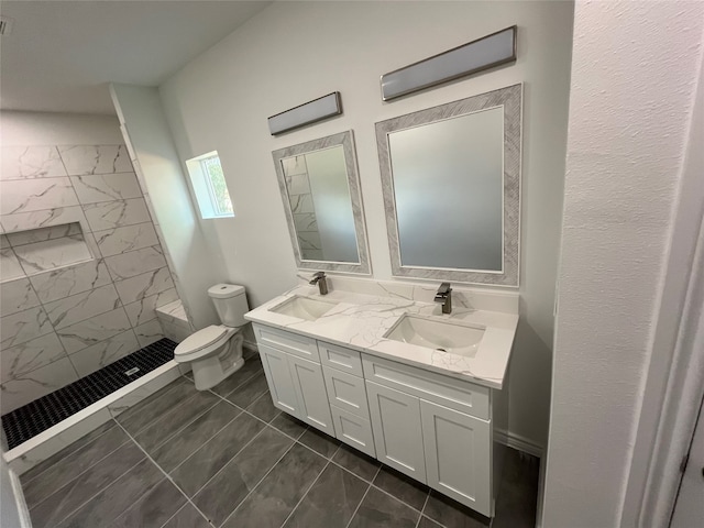 bathroom with toilet, tile patterned floors, and double vanity