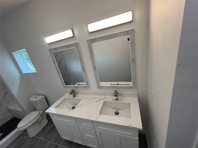 bathroom with tile patterned floors, walk in shower, double vanity, a skylight, and toilet