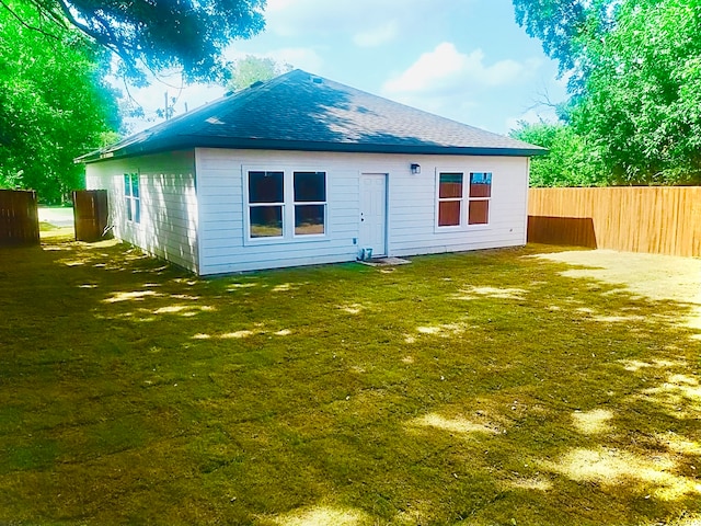 rear view of property featuring a yard