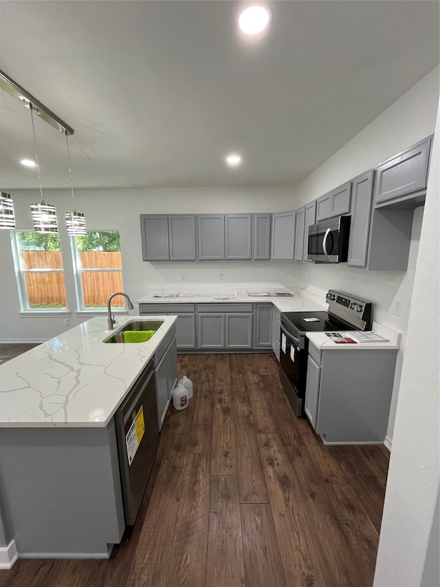 kitchen with gray cabinets, appliances with stainless steel finishes, dark hardwood / wood-style floors, and sink