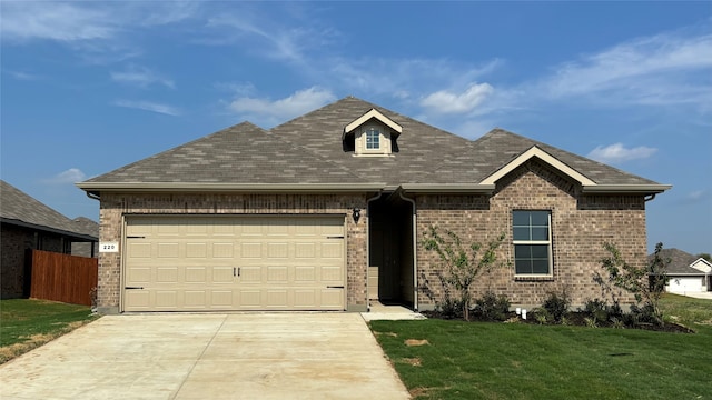 view of front facade featuring a front lawn and a garage