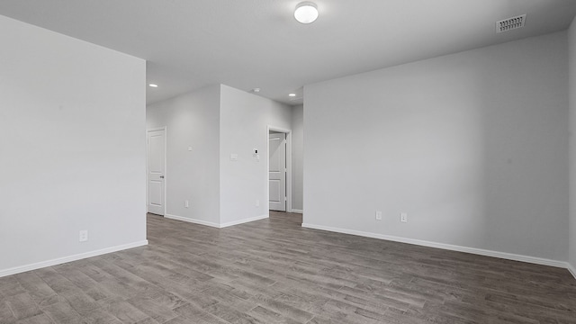 spare room featuring wood-type flooring