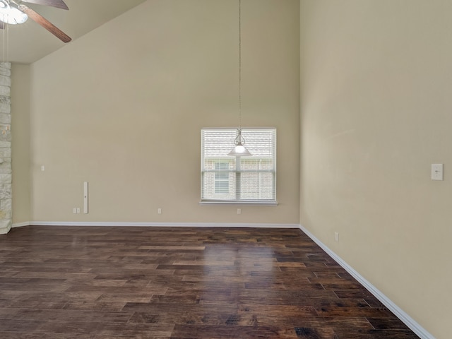 spare room with high vaulted ceiling, dark hardwood / wood-style floors, and ceiling fan