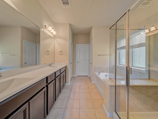 bathroom featuring independent shower and bath, double sink vanity, and tile patterned flooring