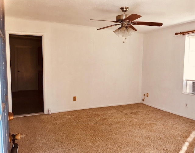 spare room with ceiling fan and carpet