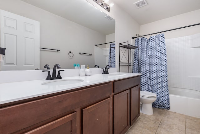 full bathroom featuring tile patterned floors, vanity, toilet, and shower / tub combo with curtain