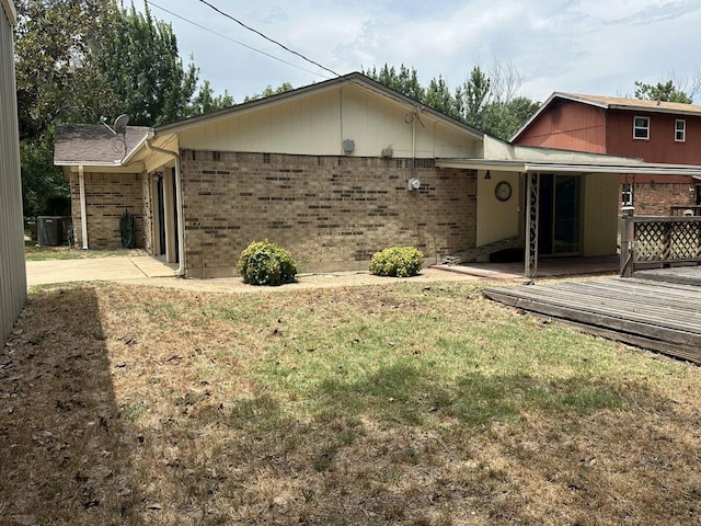 view of front of home with a front lawn and a deck