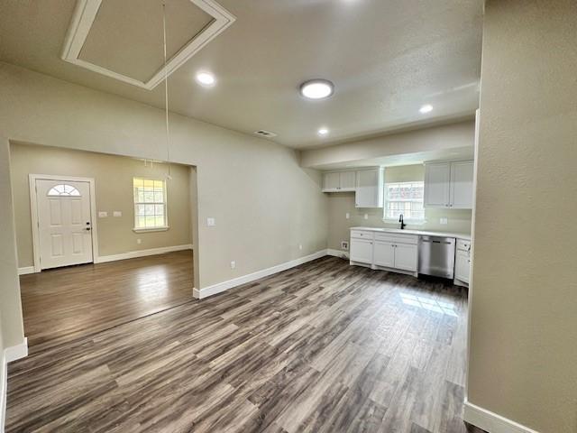 kitchen featuring stainless steel appliances, light hardwood / wood-style floors, and white cabinets