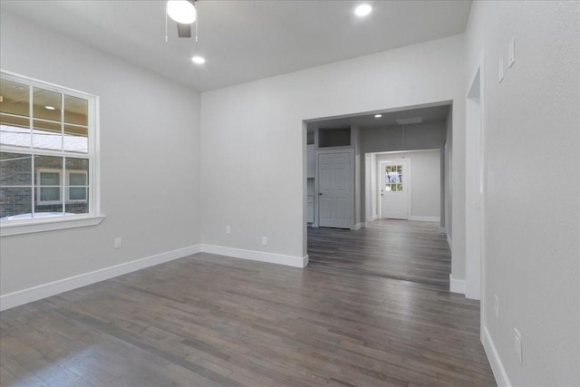 unfurnished room with dark hardwood / wood-style floors and ceiling fan