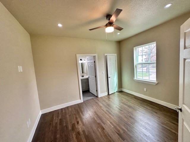 unfurnished room with dark hardwood / wood-style flooring and ceiling fan