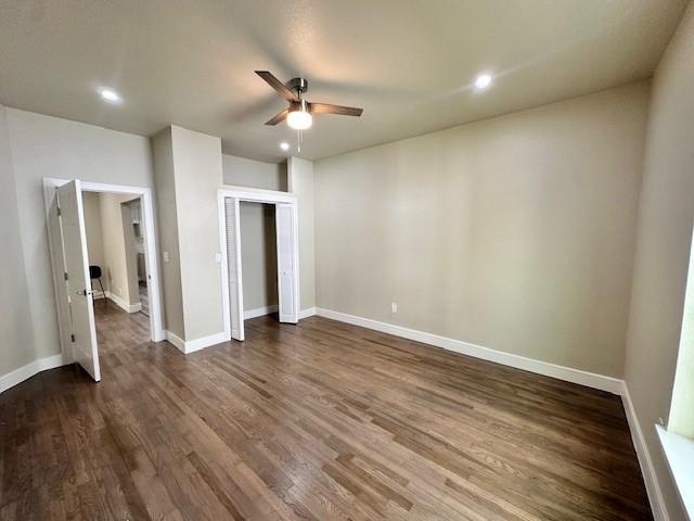 foyer entrance featuring ceiling fan, a healthy amount of sunlight, and dark hardwood / wood-style flooring