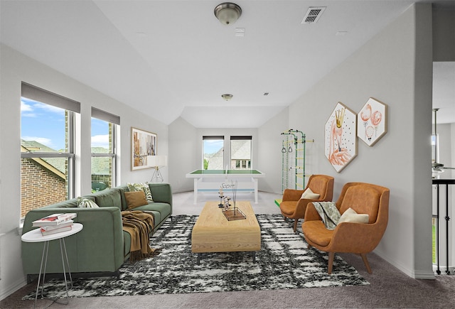 carpeted living room with vaulted ceiling